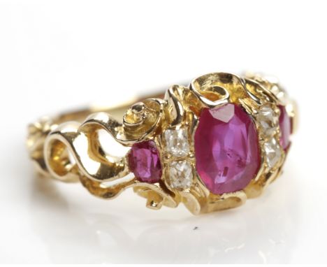 VICTORIAN RUBY AND DIAMOND RING
with a central oval cut ruby of approximately 0.70 carats, flanked by four old cushion cut di