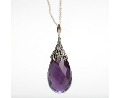 IMPRESSIVE AMETHYST AND DIAMOND PENDANT with a large briolette cut amethyst measuring approximately 40mm long, mounted in a r