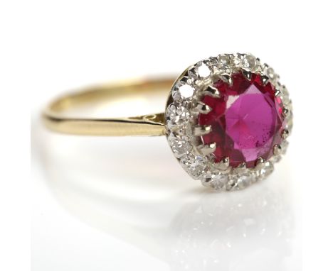 RUBY AND DIAMOND CLUSTER RING
with a central round ruby, surrounded by diamonds, in eighteen carat gold, size Q