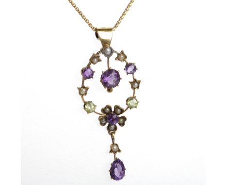 EARLY TWENTIETH CENTURY AMETHYST AND PERIDOT PENDANT
of oval floral design, in the suffragette colours, set with peridots, am