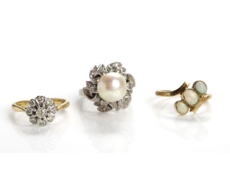 GROUP OF THREE RINGS
comprising of a diamond cluster ring, an opal three stone ring, and a pearl ring (3)