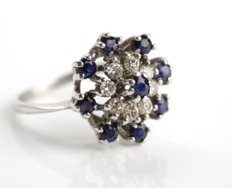 SAPPHIRE AND DIAMOND CLUSTER RING
set centrally with a round sapphire, surrounded by a row of brilliant cut diamonds, further