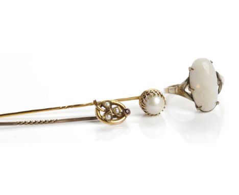 TWO EARLY TWENTIETH CENTURY PEARL SET GOLD STICK PINS
together with a nine carat gold opal set dress ring (3)