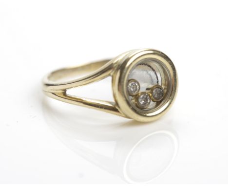EIGHTEEN CARAT GOLD HAPPY DIAMOND RING BY CHOPARD
the circular bezel set with three floating brilliant cut diamonds, signed C