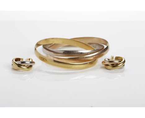 CARTIER EIGHTEEN CARAT GOLD TRI-COLOUR BANGLE AND EARRINGS
formed by three interlocking bangles in yellow, rose and white gol