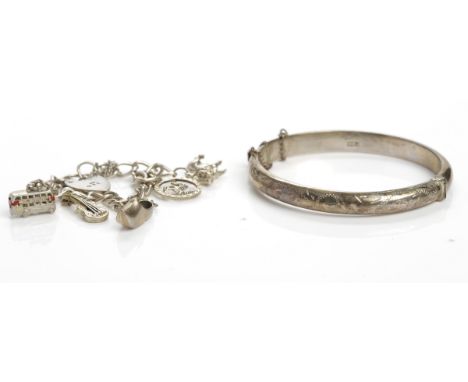 SILVER BANGLE
with engraved decoration; along with a silver bracelet