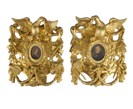 TWO GILTWOOD AND GESSO PIERCED CARVED FRAMES, each with central oval picture opening in the form of a wreath, containing mini