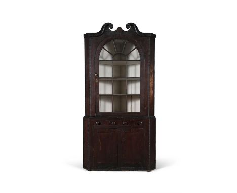 A CHIPPENDALE EBONISED AND STAINED HARDWOOD CORNER CABINET, PHILADEPHIA, CIRCA 1800, the upper section with broken swan neck 