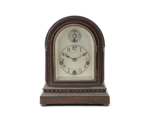 A STAINED BEECH MANTEL CLOCK, BY WINTERHALDER & HOFMEIER FOR J.E. CALDWELL & CO, PHILADELPHIA, CIRCA 1900the arched hood with