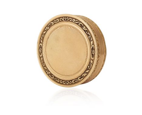 A FRENCH GOLD SNUFF BOXof circular form, the rim with foliate scroll decoration, enclosing an engine-turned centre, in 18K go