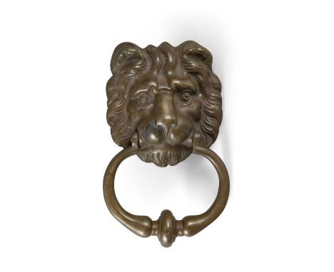 A GEORGIAN STYLE BRASS DOOR KNOCKER IN THE FORM OF A LION MASK,with ring turned knocker, 22cm high