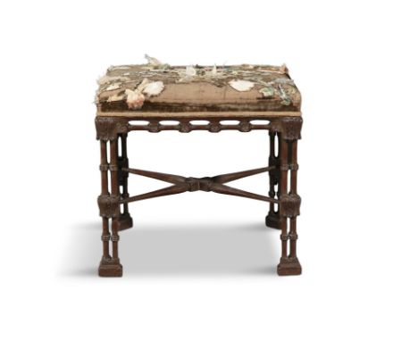 A "CHINESE CHIPPENDALE" UPHOLSTERED MAHOGANY STOOL, 19TH CENTURYwith intricately carved clustered column legs and worn brown 