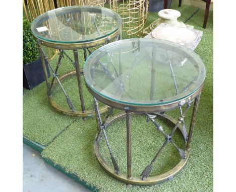 LAMP TABLES, a pair, having round glass tops on x framed bronzed cross arrow frames, 50cm diam x 53cm H. (2)