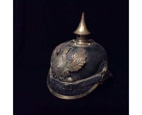 A WORLD WAR I GERMAN PICKELHAUB HELMET Mounted with a brass spike and Prussian eagle, insignia to front 'Kooning Suum Cuique 