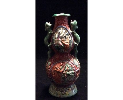 A CHINESE PORCELAIN DOUBLE GOURD VASE Incised red body having two cartouches of interlocking dragons and mouthed with two gre