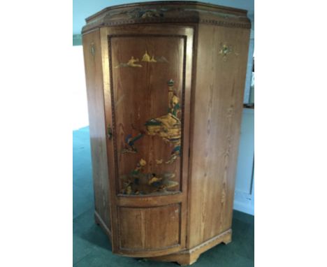 A 19TH CENTURY GOTHIC INSPIRED PINE AND CHINOISERIE DECORATED CORNER HANGING CUPBOARD  With a single bow fronted door, on pli