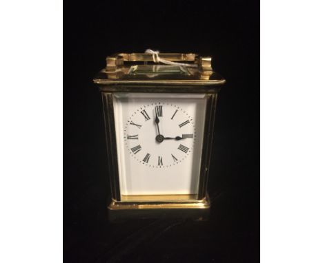 A LATE 19TH/EARLY 20TH CENTURY FRENCH BRASS CARRIAGE CLOCK Having a white rectangular dial, black Roman numerals, four bevell