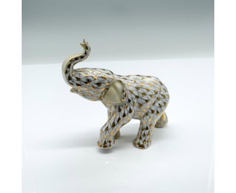 This figurine features a hand painted fishnet pattern done in 24k gold. The baby elephant was a Herend Guild 2001 Smithsonian