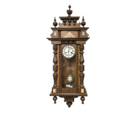 German - mid 19th century spring driven 8-day wall clock in an oak and mahogany case, with a turned and carved pediment, full