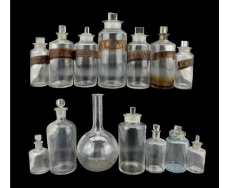 19th century and later glass apothecary bottles and jars, including a set of seven cylindrical clear glass labelled bottles w