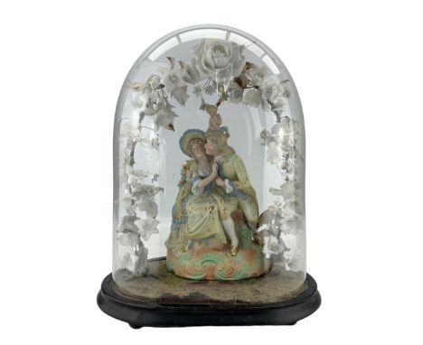 19th century bisque porcelain group of a courting couple, under an arch of porcelain flowers, in a Victorian glass dome, on a