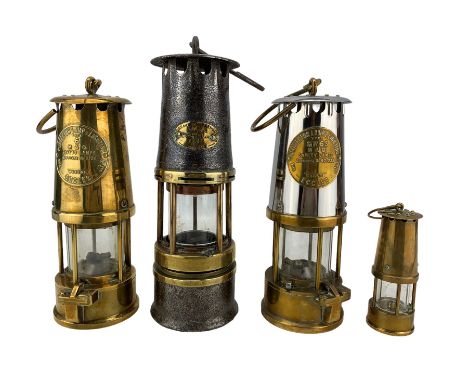 Three miners lamps comprising Eccles Type 6 and Type GR6S, Cremer miners lamp no. 11 and a miniatre brass example (4)