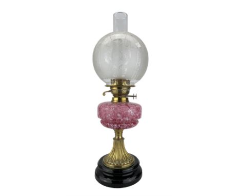Victorian brass oil lamp with pink mottled glass reservoir, globular frosted glass shade, on black glass socle base, H57cm ov