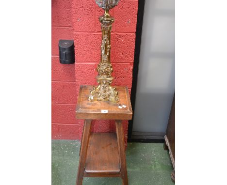 An unusual oak peg jointed lamp table and brass lamp.