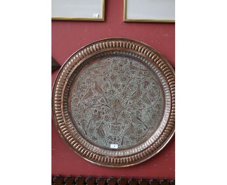 A 19th century Anglo-Indian/Persian Masonic copper charger, fluted border, the field chased with stylised birds amongst fruit