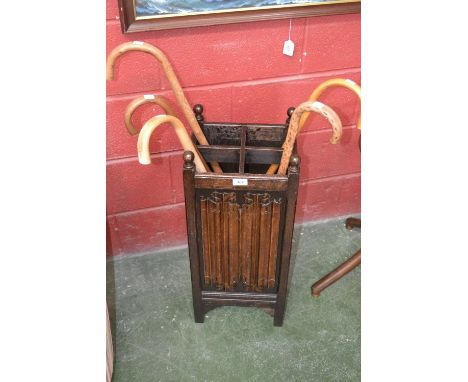 An oak linenfold stick stand and five bentwood sticks.   Condition Report:  Stand has been refurbished, two replacement corne