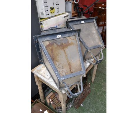 A pair of outdoor lamppost lantern tops.
