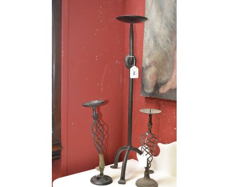 A cast iron 24" tall pricket candlestick; two brass twisted column pricket candlesticks (3)