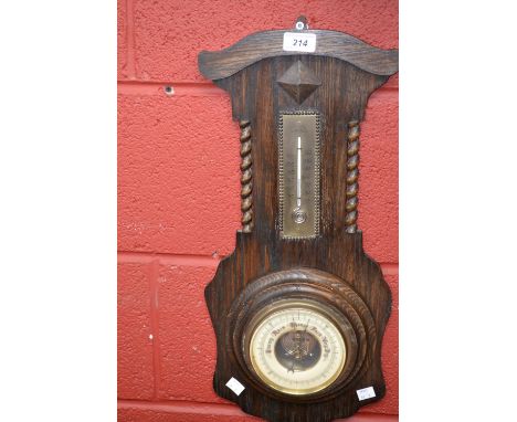 An Art Deco oak wall hanging aneroid barometer/thermometer