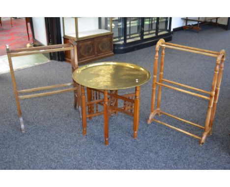 A Eastern brass tray top collapsible table; an Edwardian mahogany towel rail; a pine towel rail; a wool work tapestry. (4)   