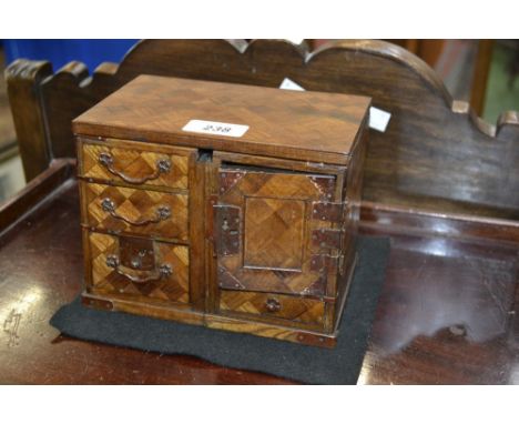 A metamorphic parquetry trinket box, converting to  a miniature sideboard.