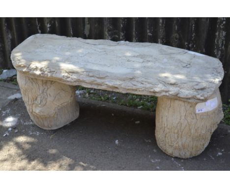 Garden ornaments - a reconstituted stone bench, simulated bark seat, tree trunk supports.