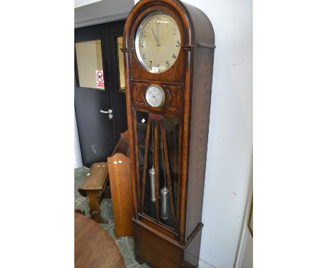 An Art Deco oak dome top longcase clock, Arabic numerals, inset barometer.