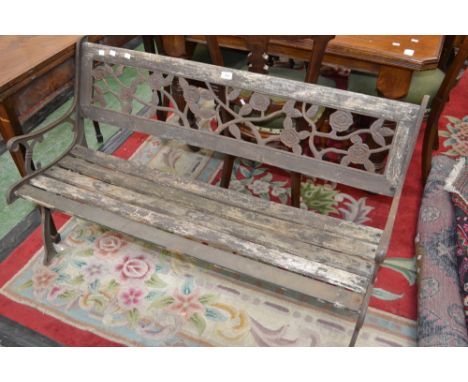 A cast iron and wooden slatted garden bench.