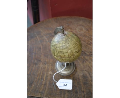 A French desk globe, of small proportions, the Sphere Terrestre, by N K Atlas, Paris, cast alloy stand, 18cm high   Condition