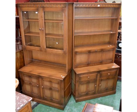 An Ercol light oak display cabinet, two glazed doors over recess to top, two panel door to base; another, shelving over fall 