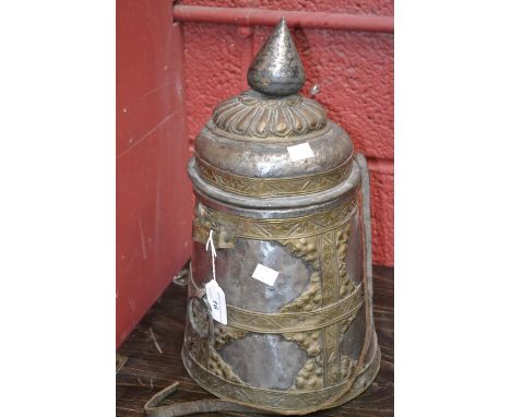 A Middle Eastern brass and tin vessel, pointed bud finial, domed cover, embossed mounts, carrying strap, 42cm high, early 20t