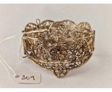 A fancy filigree design wide hinged bangle