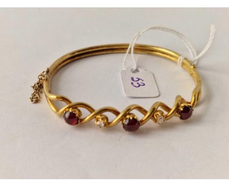 A VICTORIAN CABOCHON GARNET AND DIAMOND BANGLE 15CT GOLD TESTED BOXED