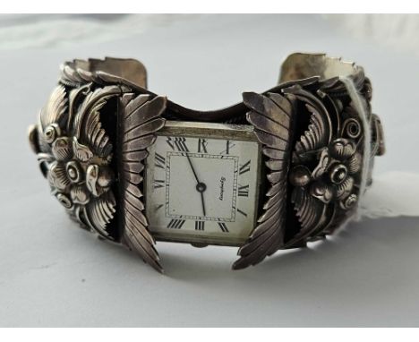 An unusual silver bangle watch by Symphony with unusual floral design, 95 g. inc