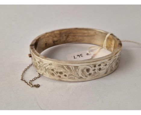 A good wide floral design silver hinged bangle
