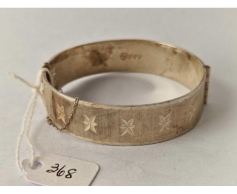 A good wide star design silver hinged bangle
