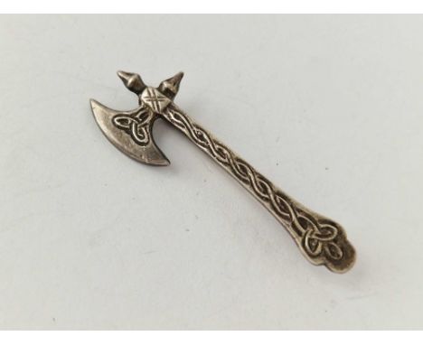 A silver axe brooch