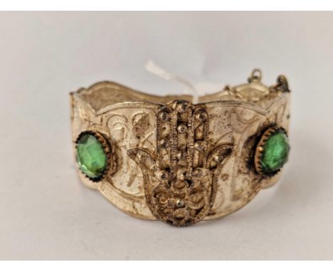 An Egyptian white metal ornate bangle, decorated with two large blue stones