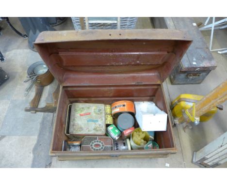 A tin trunk containing advertising tins