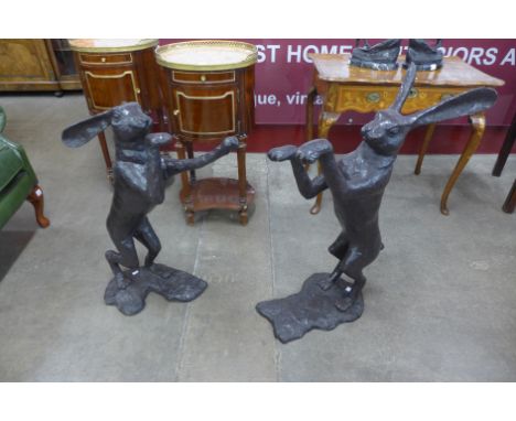 A pair of bronze boxing hares, height 77cms